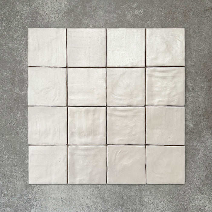 Zellige Oyster Square Moroccan-style ceramic tiles in a 10 × 10cm format, shown in a grouped layout highlighting the soft oyster-white glaze and subtle handmade surface variation.