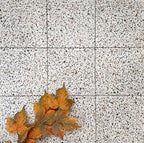 Floor installation featuring Turin Terrazzo Blanco Dots porcelain tiles in a 20 × 20cm format, laid in a neat grid pattern with subtle grout lines, showcasing the light terrazzo-style surface with scattered multicoloured stone fragments for a clean, contemporary look.