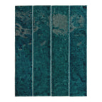 Bora Bora Amun Blue Brick ceramic wall tile in a 6.5 × 32.8cm slim brick format, featuring deep blue-green tones with natural flux glaze variation and subtle surface texture, shown as a single tile on a white background.