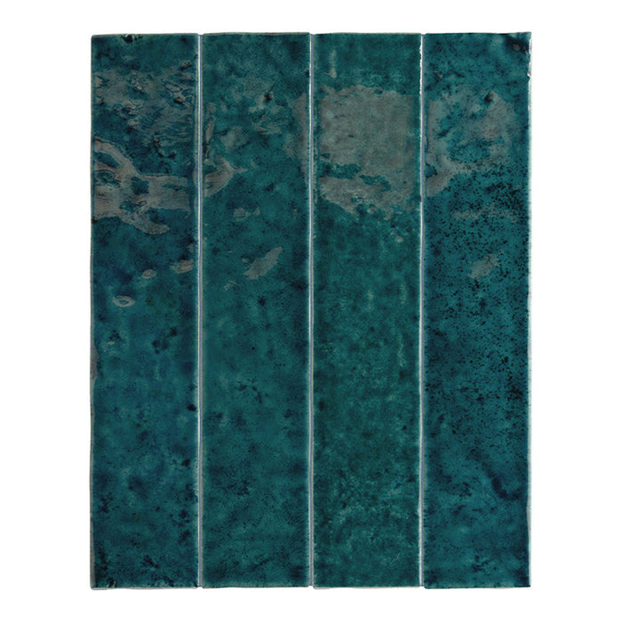 Bora Bora Amun Blue Brick ceramic wall tile in a 6.5 × 32.8cm slim brick format, featuring deep blue-green tones with natural flux glaze variation and subtle surface texture, shown as a single tile on a white background.