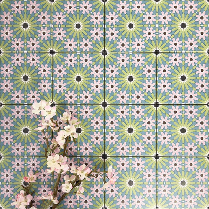Fez Mini Summer 15x15cm Moroccan-style porcelain wall tiles arranged in a repeating geometric pattern, featuring soft green, blue and blush pink star motifs, styled with delicate floral stems for a fresh, decorative finish.