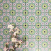 Fez Mini Summer 15x15cm Moroccan-style porcelain wall tiles arranged in a repeating geometric pattern, featuring soft green, blue and blush pink star motifs, styled with delicate floral stems for a fresh, decorative finish.