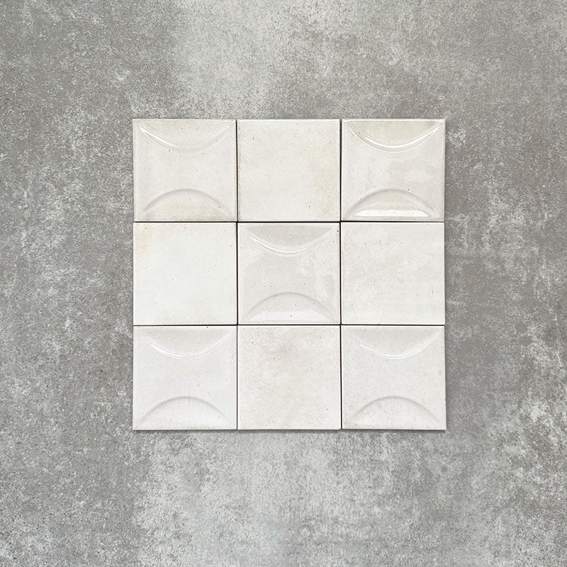 Saigon White Square Wall tiles shown in a grouped layout, featuring Moroccan-style 10 × 10cm glossy ceramic tiles in soft white tones with subtle surface texture and tonal variation.