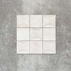 Saigon White Decor Square Wall tiles shown in a grouped layout, featuring Moroccan-style 10 × 10cm glossy ceramic tiles in soft white tones with a curved decorative relief pattern.