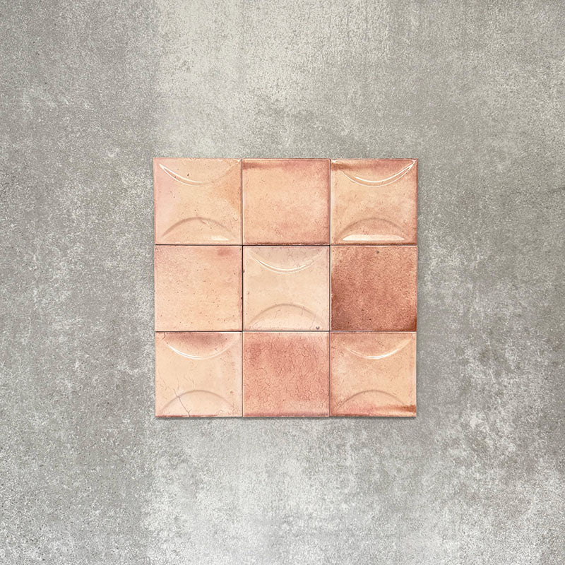 Close-up of Saigon Rose Pink Decor Square Wall tiles, featuring Moroccan-style 10 × 10cm glossy ceramic tiles in soft blush and rose tones with a curved decorative relief pattern.