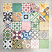 Fayrouz Mini Patchwork 15×15cm Moroccan-style porcelain tiles displayed as a mixed patchwork layout, showcasing a vibrant collection of geometric and floral designs in green, blue, pink, mustard, terracotta and neutral tones.