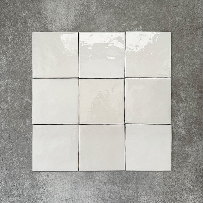 Zellige White square Moroccan-style ceramic tiles in a 13.2 × 13.2cm format, shown in a clean grid layout with a softly uneven, glossy finish.