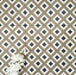 Viscount Park Road 20×20cm Victorian-style porcelain wall and floor tiles laid in a repeating geometric diamond pattern in olive green, white and dark grey, shown as a full tile layout with subtle tonal variation and white floral styling.