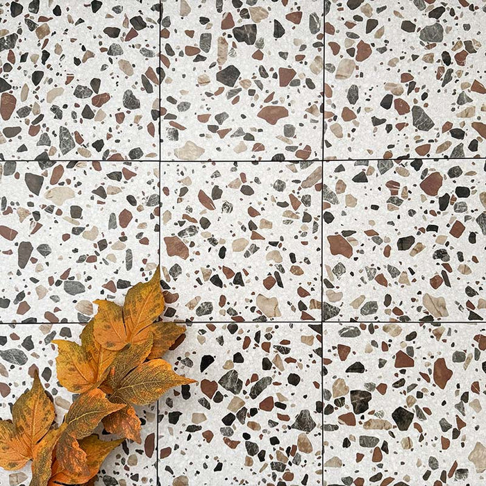 Turin Terrazzo Blanco Drops porcelain tiles in a 20 × 20cm format, laid in a clean grid pattern to showcase the terrazzo-style surface with larger scattered stone fragments in warm neutral tones, creating a contemporary and characterful floor finish.