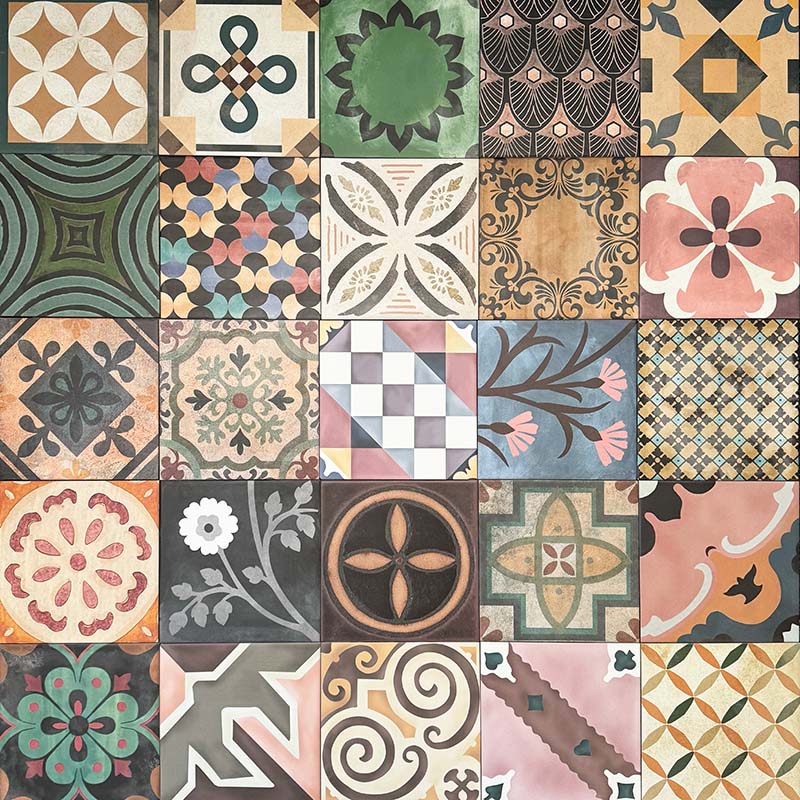 Cuba Patchwork Moroccan-style porcelain tiles in a 20×20cm square format, arranged in a mixed patchwork layout featuring a variety of geometric, floral and traditional motifs in earthy, green, blue and terracotta tones, highlighting the tile’s eclectic, encaustic-style design and rich visual texture.