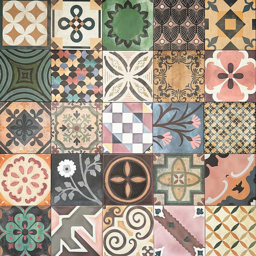 Cuba Patchwork Moroccan-style porcelain tiles in a 20×20cm square format, arranged in a mixed patchwork layout featuring a variety of geometric, floral and traditional motifs in earthy, green, blue and terracotta tones, highlighting the tile’s eclectic, encaustic-style design and rich visual texture.