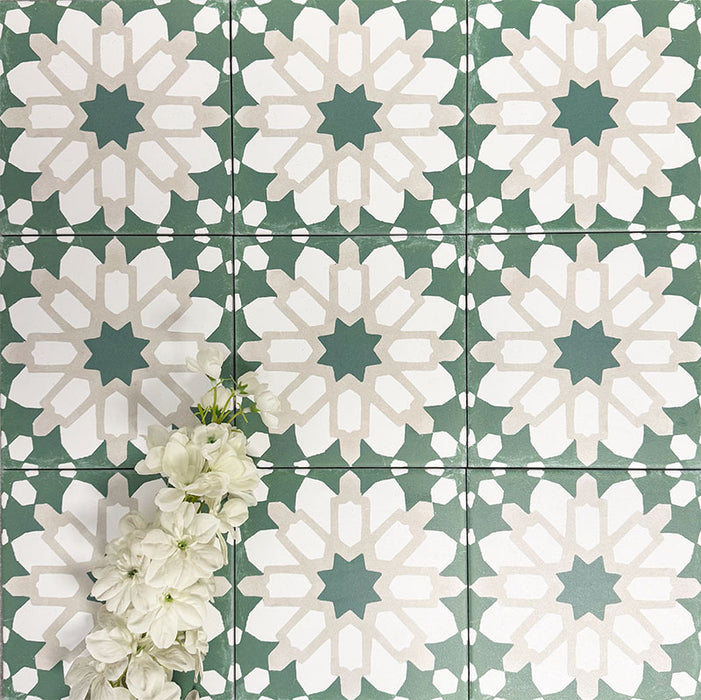 Souk Green D 20×20cm Moroccan-style porcelain tiles arranged in a green, white and beige geometric pattern.