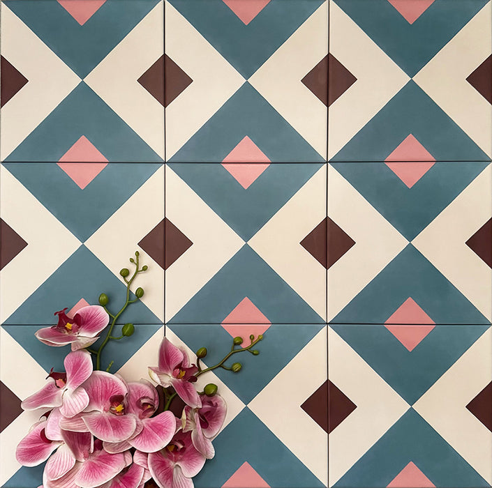 Cuba Guazzatto Moroccan-style porcelain tiles in a 20×20cm square format, arranged in a repeating geometric diamond pattern in soft blue, white, pink and burgundy tones, styled with floral accents to highlight the tile’s bold symmetry and contemporary encaustic-style design.