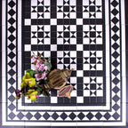 Hallway floor featuring Dorset Black & White Victorian-style porcelain tiles in a 25 × 25cm format, laid in a detailed geometric pattern with coordinating border and corner tiles to create a striking framed design with classic black and white contrast.