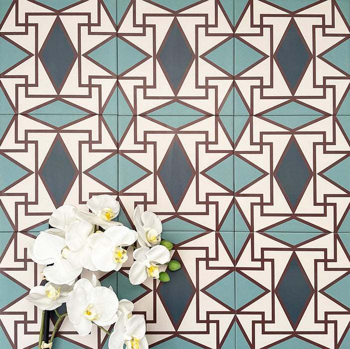 Abstract Iris Patterned Tiles in a 20x20cm format, displayed in a repeated grid layout to showcase the intricate geometric design. Soft teal and cream tones are contrasted with deep blue diamond motifs and fine red detailing, creating a bold, decorative pattern ideal for feature walls, floors or statement splashbacks.