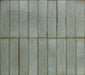 Puzzle Sage Green Brick Rectified 5x20cm porcelain tiles displayed in a full layout, showcasing soft sage green tones with gentle speckling and natural shade variation across each brick. The rectified edges create clean, uniform lines, while the subtle surface texture adds depth and a refined handmade aesthetic to both wall and floor installations.