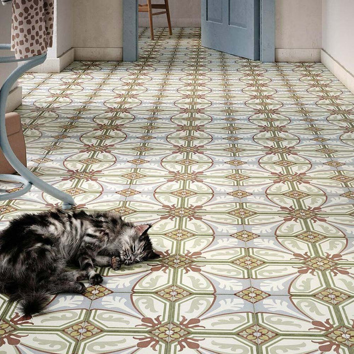 Victorian-style hallway featuring Viscount Langholme Place 20×20cm porcelain wall and floor tiles laid in a repeating ornate floral and geometric pattern in soft blue, sage green, warm red and cream tones, styled with pale blue doors, classic furnishings and a relaxed, characterful feel.