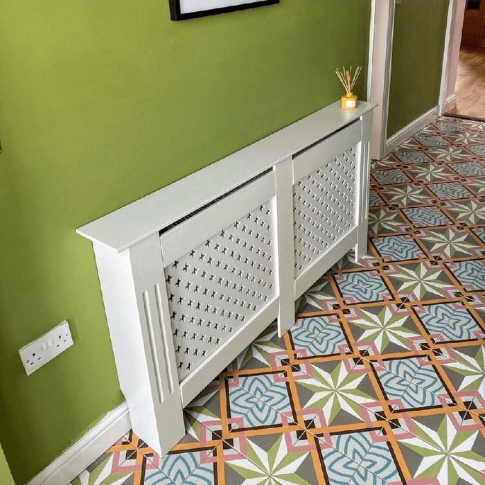 Hallway floor featuring Cuba Star Moroccan-style porcelain tiles in a 20×20cm square format, laid in a repeating geometric pattern with soft green, blue, pink and mustard tones, paired with green walls and wooden doors to create a vibrant, characterful entrance.