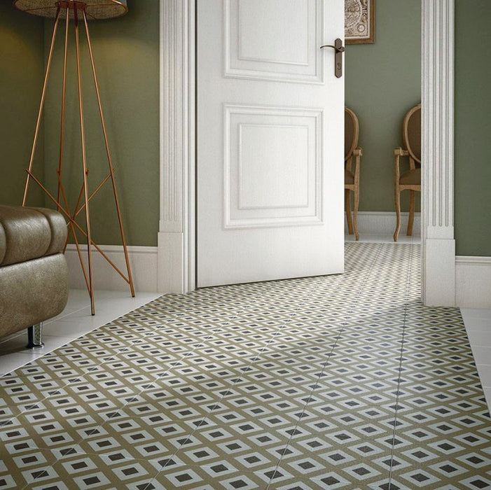Victorian-style hallway featuring Viscount Park Road 20×20cm porcelain wall and floor tiles laid in a repeating geometric pattern, styled with soft green walls, classic door detailing and warm brass accents for a timeless, elegant look.