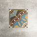 Single London Streets Hanover Square 20x20cm Victorian Moroccan style porcelain tile displayed in a product setting, featuring an ornate geometric pattern in blue, terracotta, cream and dark brown tones inspired by traditional decorative floor tiles.
