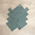 Pimlico River Blue 7.5 × 15cm ceramic wall tiles with a crackle glaze finish, shown in a herringbone layout that highlights deep blue tones, subtle texture and versatile design options for kitchens and bathrooms.