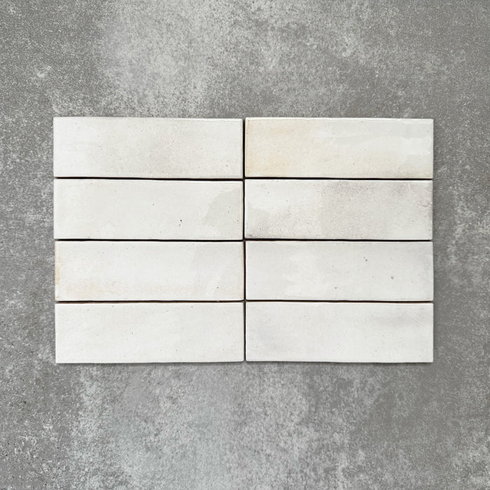 Saigon White Brick Wall tiles laid horizontally, featuring Moroccan-style 5.1 × 16.1cm glossy ceramic tiles in soft white tones with subtle tonal variation.