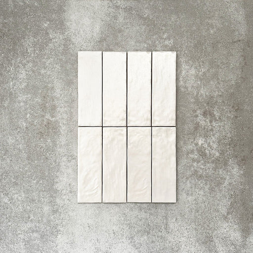 Zellige Oyster Brick Moroccan-style ceramic tiles in a 6.5 × 20cm format, arranged to show the slim brick shape with subtle surface variation and soft oyster tones, highlighting the handmade-look texture suitable for wall applications.