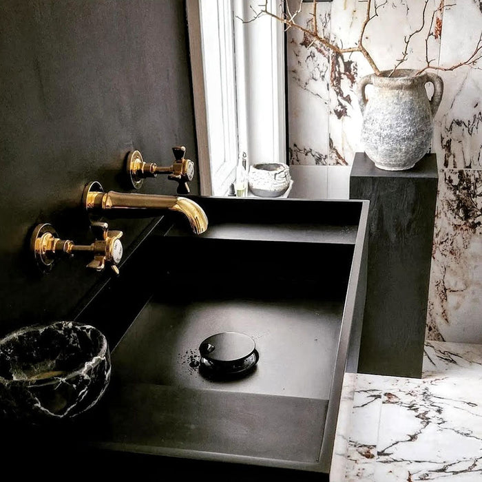 Bathroom interior featuring Hudson Capraia Matt Marble 60 × 60cm porcelain wall and floor tiles, styled with bold dark veining against a soft white base, paired with black fixtures and warm brass accents for a striking, contemporary contrast.