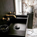 Bathroom interior featuring Hudson Capraia Matt Marble 60 × 60cm porcelain wall and floor tiles, styled with bold dark veining against a soft white base, paired with black fixtures and warm brass accents for a striking, contemporary contrast.
