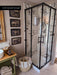 Customer bathroom featuring Hudson Capraia matt marble effect porcelain tiles in a walk-in shower. Large-format 60cm x 60cm white marble effect wall tiles with bold grey veining are paired with a black framed shower enclosure, creating a timeless and elegant bathroom design.