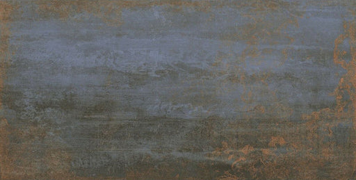 Close-up of Iron Blue Oxide Metallic 30 × 60cm porcelain tile, highlighting deep blue tones layered with warm oxidised copper accents, soft tonal variation, and a gently textured metallic effect for a bold, industrial-inspired finish.