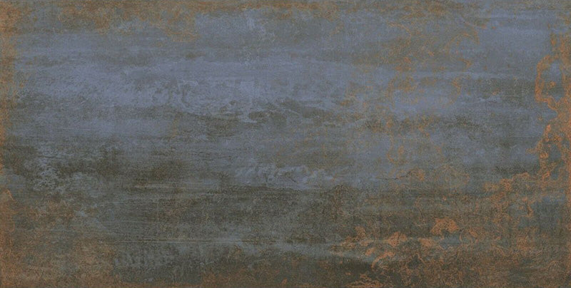 Close-up of Iron Blue Oxide Metallic 30 × 60cm porcelain tile, highlighting deep blue tones layered with warm oxidised copper accents, soft tonal variation, and a gently textured metallic effect for a bold, industrial-inspired finish.