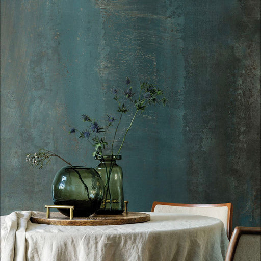 Interior setting featuring Iron Cuprum Oxide Metallic 60 × 120cm porcelain wall tiles, showcasing deep blue-green tones layered with warm copper oxidation and soft tonal variation, paired with natural wood and glass accents for a rich, atmospheric, industrial-inspired finish.