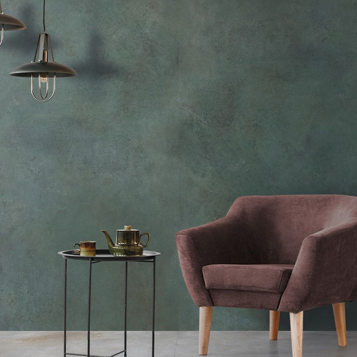 Living space detail featuring Iron Emerald Green Oxide Metallic 30 × 60cm porcelain wall tiles, showcasing deep green tones with subtle tonal variation and a soft metallic effect, paired with warm upholstery, light wood legs, and minimal styling for a calm, contemporary contrast.