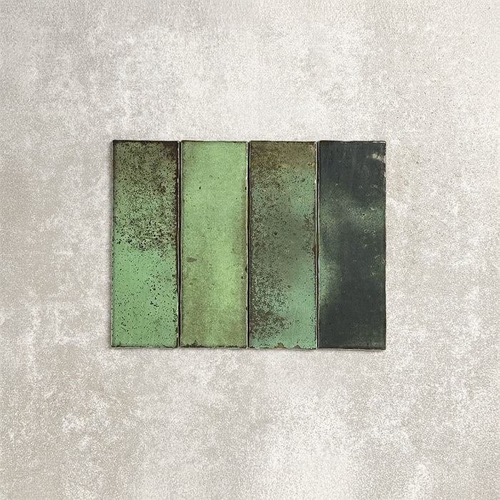 Close-up of Foundry Bricks Jade Green 6.5x20cm brick wall tiles, showcasing varied green tones with rich tonal variation, lightly textured surfaces and gently irregular edges for a refined, contemporary finish.