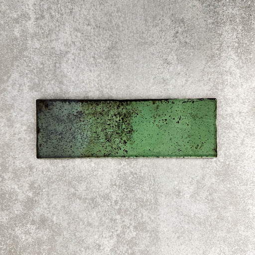 Close-up of Foundry Bricks Jade Green 6.5x20cm brick wall tile, showcasing varied green tones with rich tonal variation, lightly textured surface and gently irregular edges for a refined, contemporary finish.