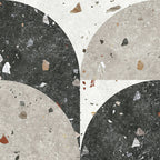 Flat lay of Jericho Decor Terrazzo 66 × 66cm porcelain wall and floor tile, featuring a terrazzo base with multicoloured aggregate chips combined with bold geometric quarter-circle patterning in contrasting light and dark tones, creating a striking, contemporary statement design.
