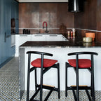 Kitchen setting featuring Viscount Park Road 20x20cm Victorian style wall and floor tiles, showcasing a repeating geometric pattern in soft grey and white tones, paired with rich brown wall tiles, dark worktops and contemporary cabinetry for a bold, design-led finish.