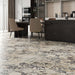 Kitchen interior featuring Fayrouz Picasso 30.5x61cm natural marble tiles with a honed finish, installed across the floor to showcase a white base with bold grey, green and warm gold veining, creating a striking, high-impact surface with rich natural variation.