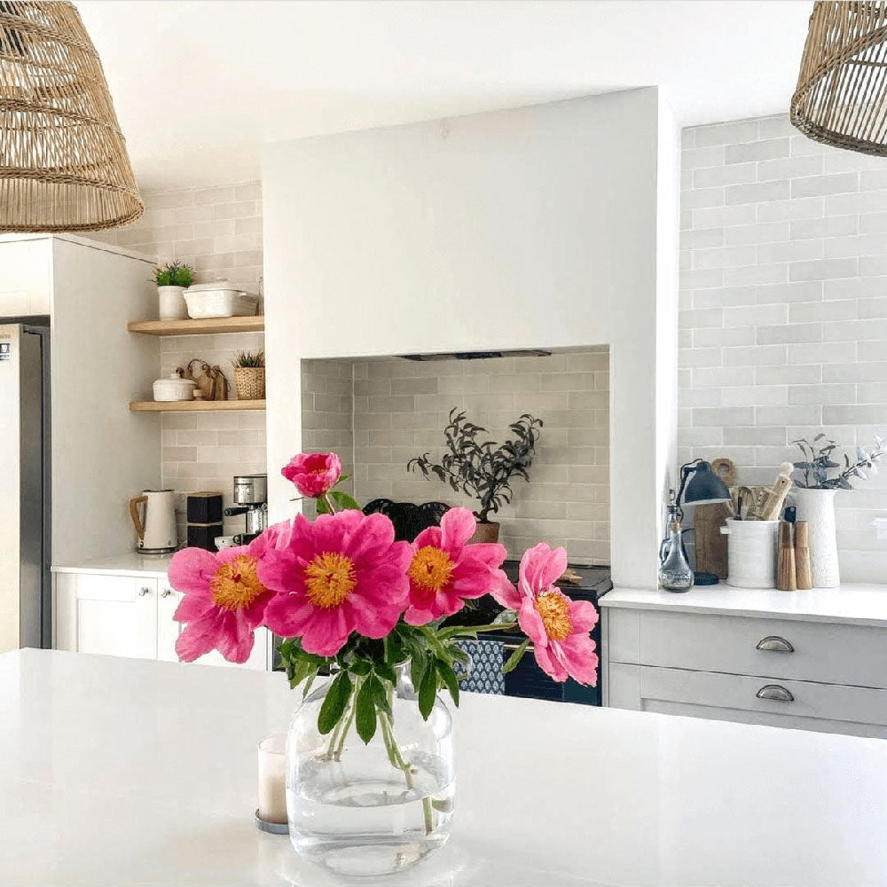 Zellige Chalk White Moroccan-style brick tiles used as a kitchen splashback, creating a soft, handcrafted finish behind open shelving and worktops.