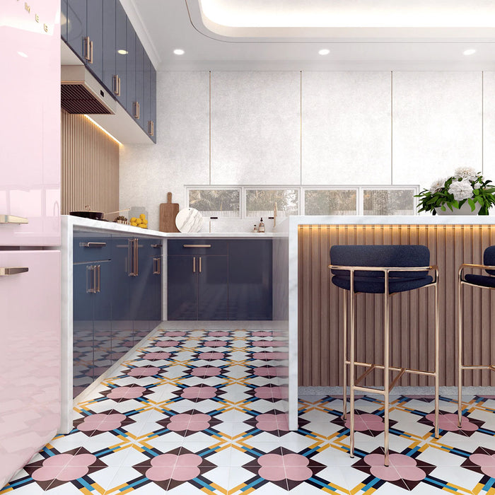 Kitchen interior featuring Abstract Contori Patterned Tiles in a 20x20cm format, laid as a decorative floor design. The elegant geometric pattern combines soft blush pink, muted green, mustard yellow and charcoal tones, paired with modern cabinetry, marble worktops and brass bar stools to create a stylish, contemporary kitchen setting.