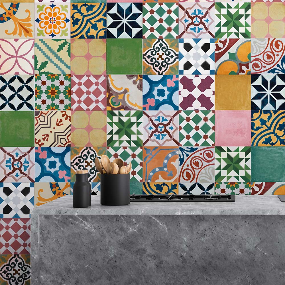 Fayrouz Mini Patchwork 15×15cm Moroccan-style porcelain tiles used as a kitchen splashback, featuring a vibrant mix of geometric and floral patterns in green, blue, pink, mustard and warm neutral tones.