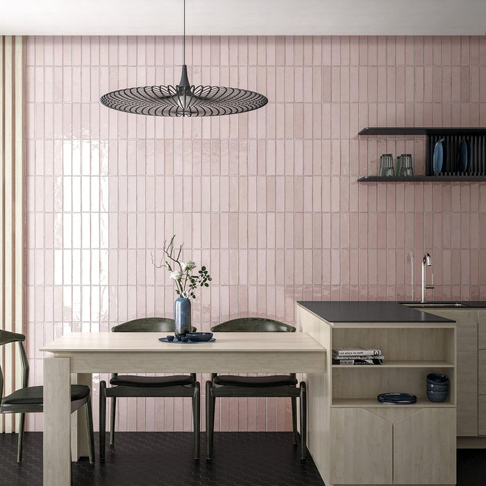 Kitchen featuring Nomad Rose brick wall tiles in a 6 × 24.6cm format, laid vertically to create a soft pink, industrial-inspired feature wall behind the dining area.