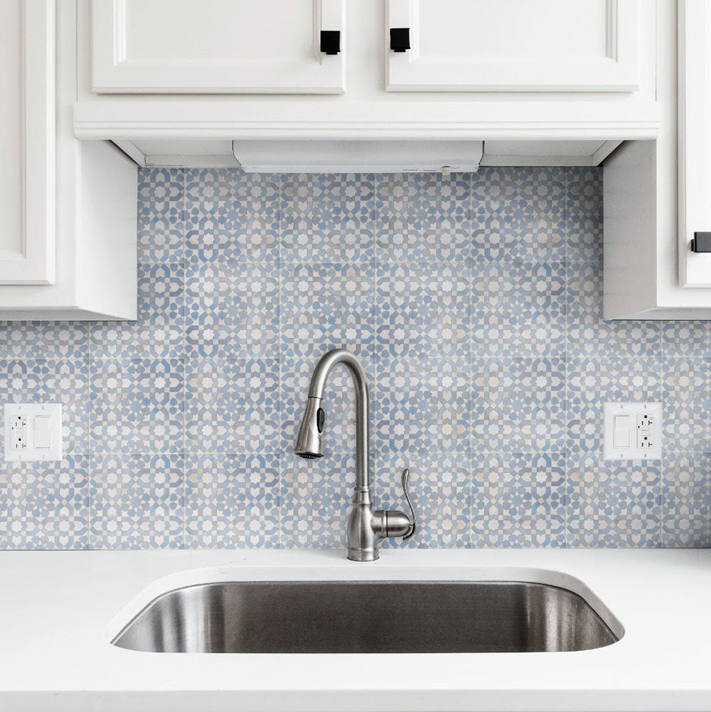 Kitchen splashback featuring Berber Tetuan Blue 15×15cm Moroccan-style porcelain tiles, showcasing a soft blue geometric pattern styled with white cabinets.