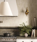 Kitchen setting featuring Benomar Canvas Moroccan style mini brick tiles in a 5x15cm format, finished in a soft matt surface. Laid vertically, the slim proportions create a subtle sense of height while enhancing the handcrafted, textural feel across the wall.