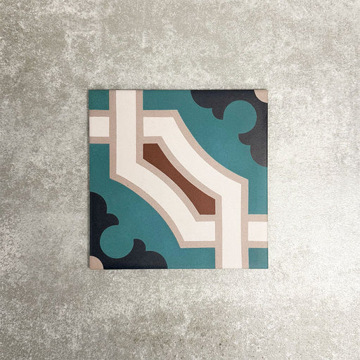 Single London Streets Leicester Square 20x20cm Victorian Moroccan style porcelain tile displayed in a product setting, featuring a geometric pattern in teal, cream and terracotta tones inspired by traditional decorative Victorian style floor tiles.