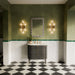 Bathroom featuring Levent Antique White Fluted Decor 6cm x 24cm gloss porcelain wall tiles, paired with green trim, textured walls, black and white chequerboard floor tiles and brass details.