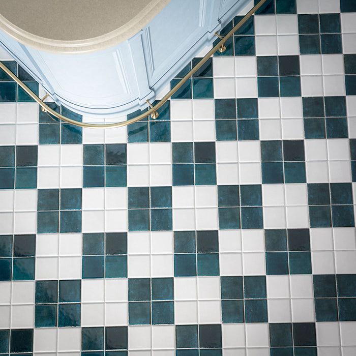 Kitchen featuring Levent Antique White Square 10cm x 10cm gloss porcelain wall and floor tiles in a classic chequerboard design, combining glossy antique white and deep teal squares with subtle shade variation, brass handrail and traditional architectural details.