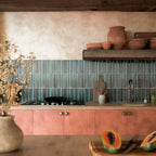Kitchen featuring Levent Blue Fluted Decor 6cm x 24cm gloss porcelain wall tiles, laid vertically as a splashback and paired with terracotta cabinetry, wooden shelving and rustic décor.