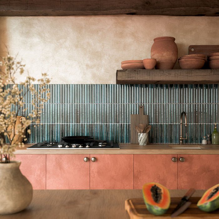 Kitchen featuring Levent Blue Fluted Decor 6cm x 24cm gloss porcelain wall tiles, laid vertically as a splashback and paired with terracotta cabinetry, wooden shelving and rustic décor.